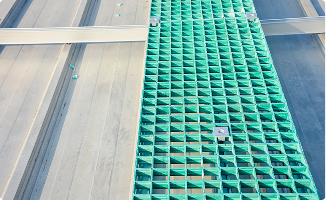 Image (3) - Kent Pultrusion Structural composite green FRP walkway grating installed on a metal industrial rooftop